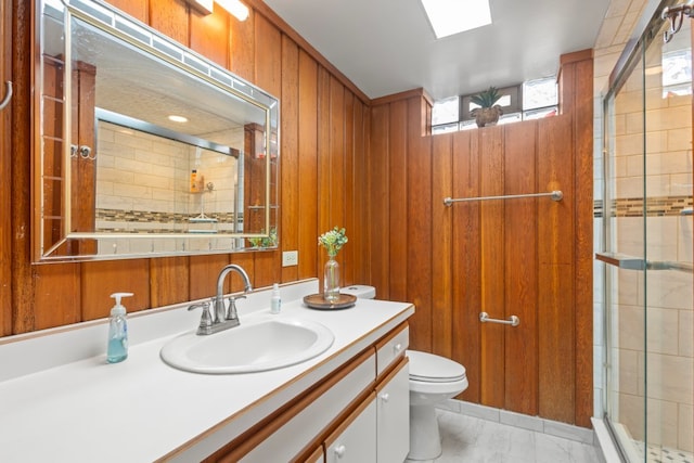 bathroom featuring wooden walls, toilet, an enclosed shower, and vanity