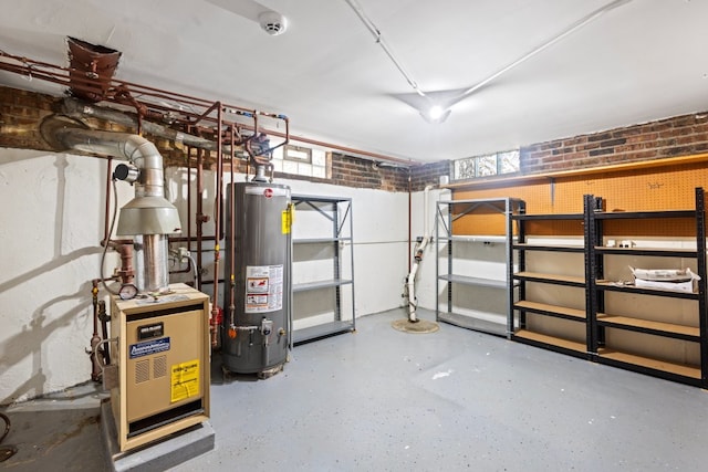 basement featuring gas water heater and brick wall