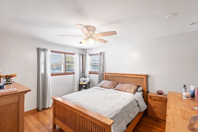 bedroom with light hardwood / wood-style flooring and ceiling fan