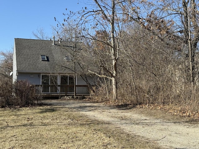 view of front of house with a front yard and a deck