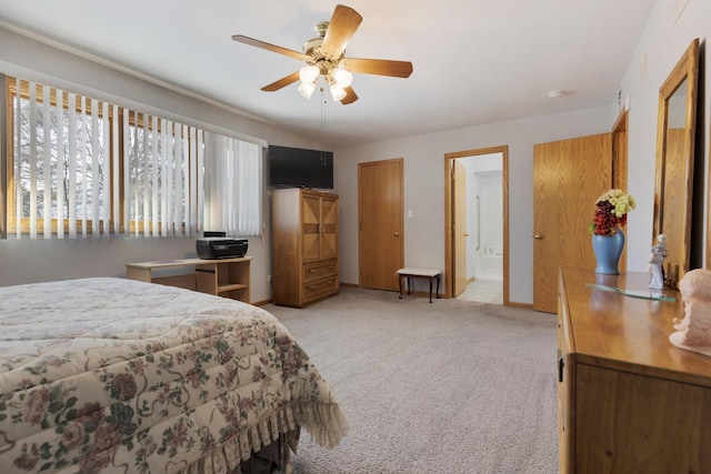 carpeted bedroom with ceiling fan and ensuite bathroom