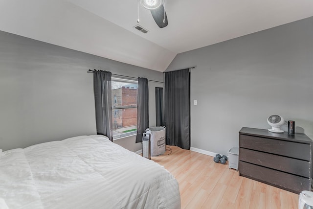 bedroom featuring ceiling fan, lofted ceiling, and light hardwood / wood-style floors