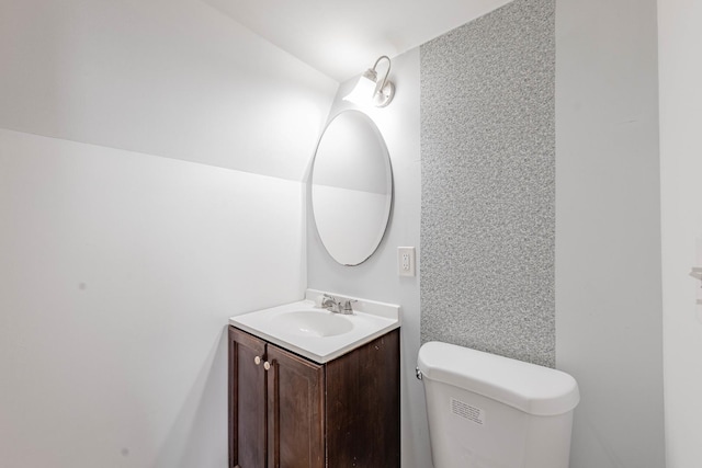 bathroom featuring toilet and vanity