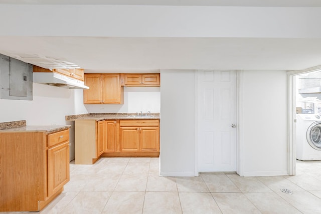 kitchen with washer / dryer, light tile patterned floors, electric panel, and sink