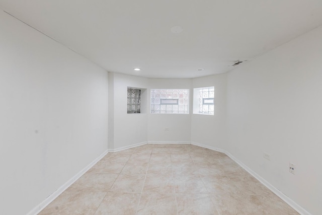 spare room featuring light tile patterned flooring