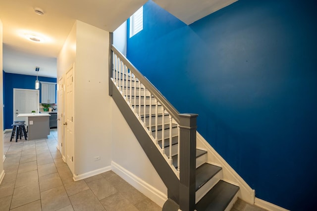 stairs featuring tile patterned flooring