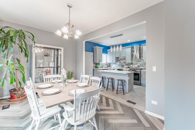 dining area featuring light parquet floors and a chandelier