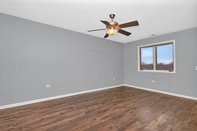 spare room with ceiling fan and dark hardwood / wood-style flooring