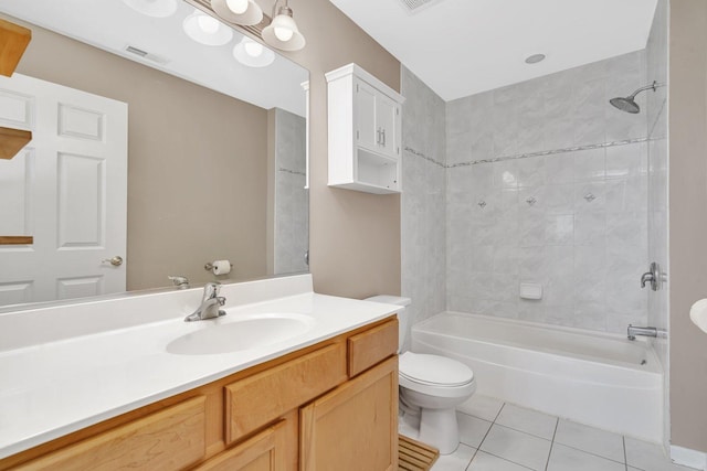 full bathroom featuring toilet, vanity, tile patterned flooring, and tiled shower / bath