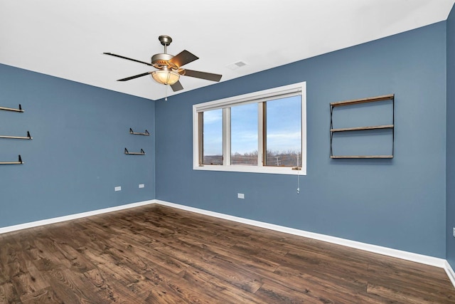 empty room with ceiling fan and dark hardwood / wood-style floors