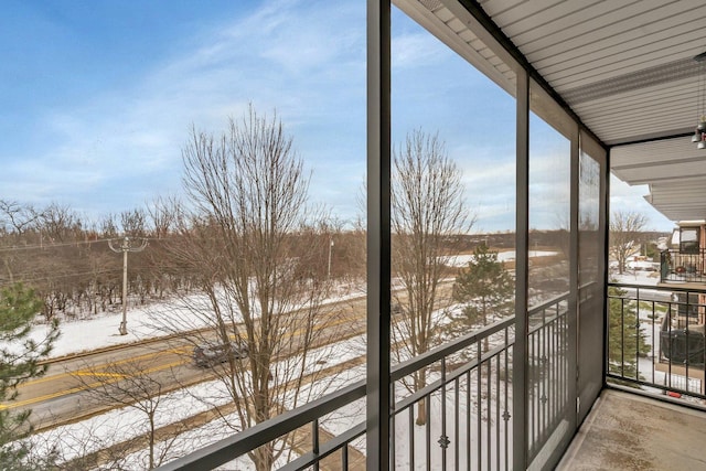 view of snow covered back of property