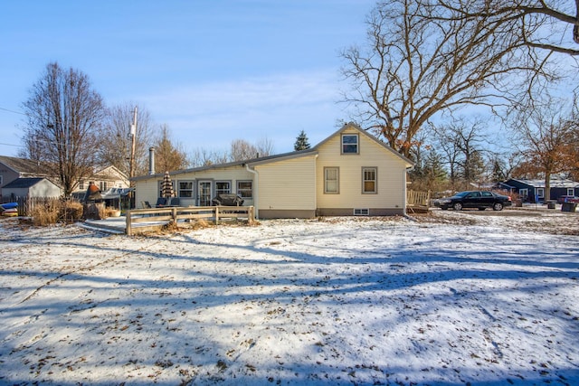 view of snow covered back of property