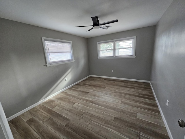 empty room with hardwood / wood-style flooring and ceiling fan