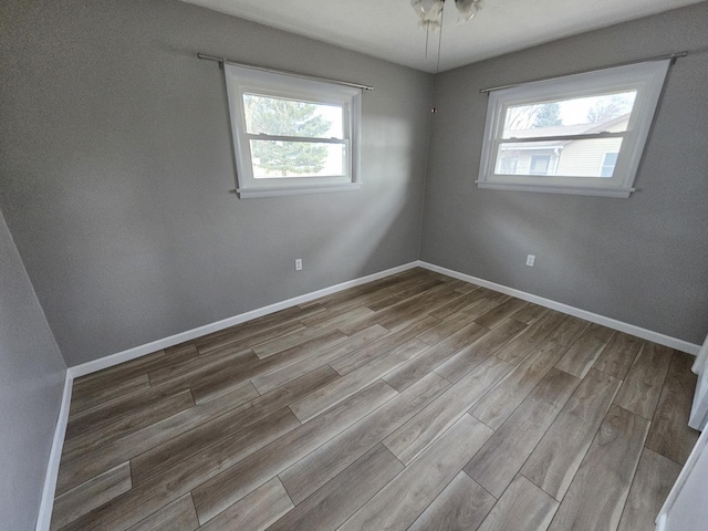 empty room with light hardwood / wood-style flooring