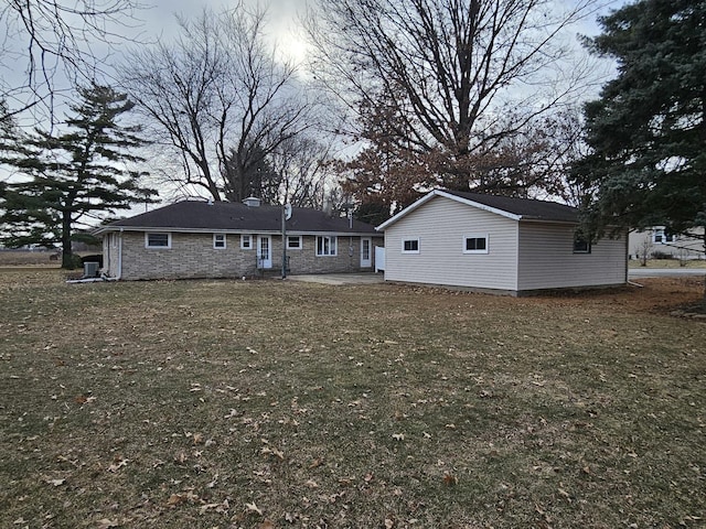 back of house with a patio area and a yard