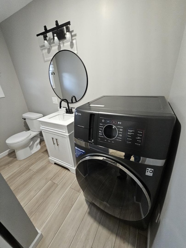 laundry area featuring washer / clothes dryer and sink