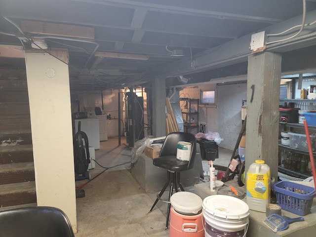 basement featuring washing machine and clothes dryer and water heater