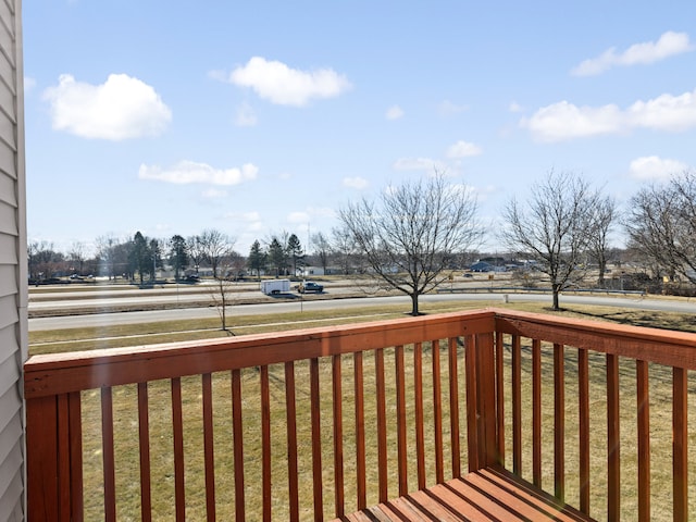 wooden deck with a lawn