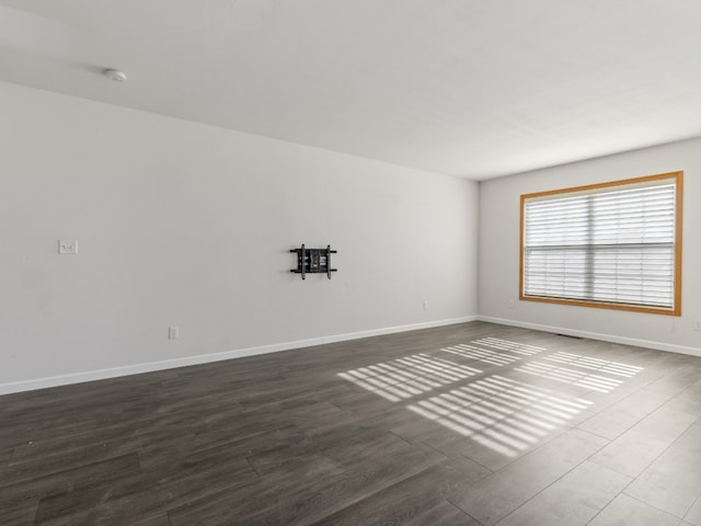 empty room with dark hardwood / wood-style floors