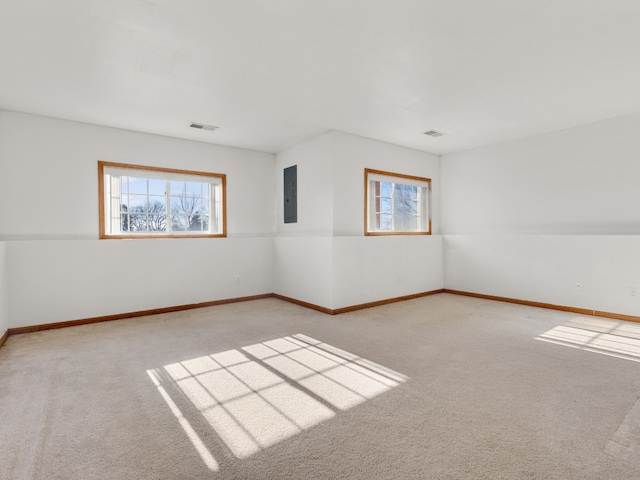 carpeted empty room with electric panel