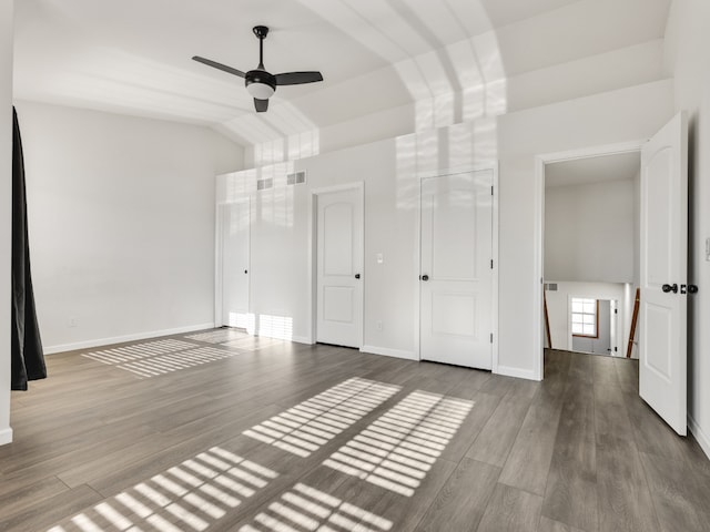 unfurnished bedroom featuring ceiling fan, light hardwood / wood-style floors, and vaulted ceiling