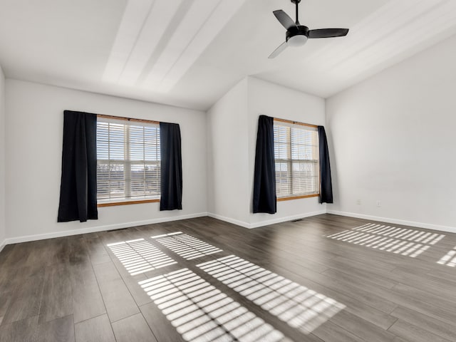 spare room with ceiling fan, plenty of natural light, and hardwood / wood-style floors