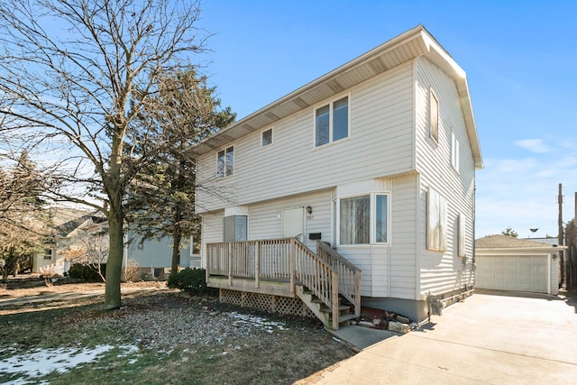 view of front of house with a garage and an outdoor structure