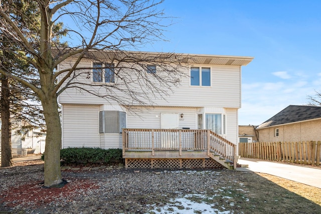 back of property featuring a wooden deck