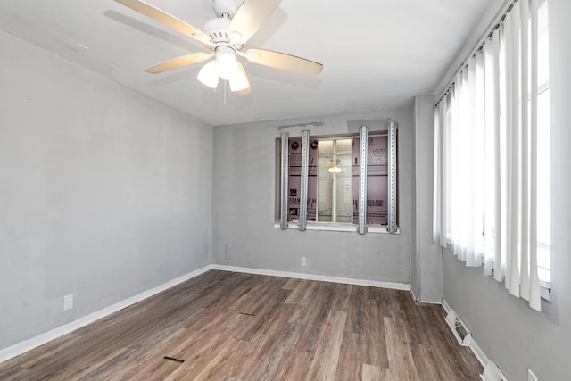 spare room with hardwood / wood-style flooring and ceiling fan