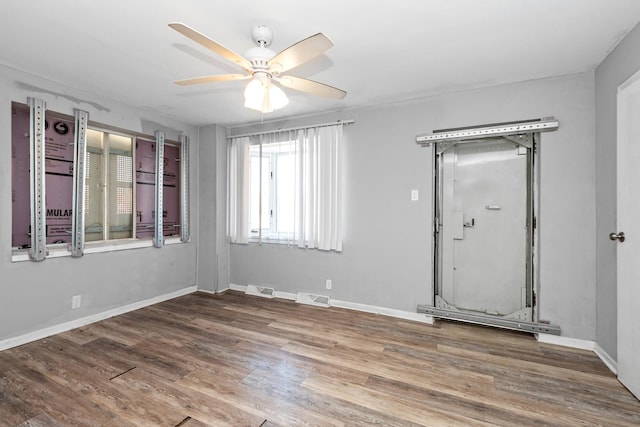 spare room with hardwood / wood-style flooring and ceiling fan