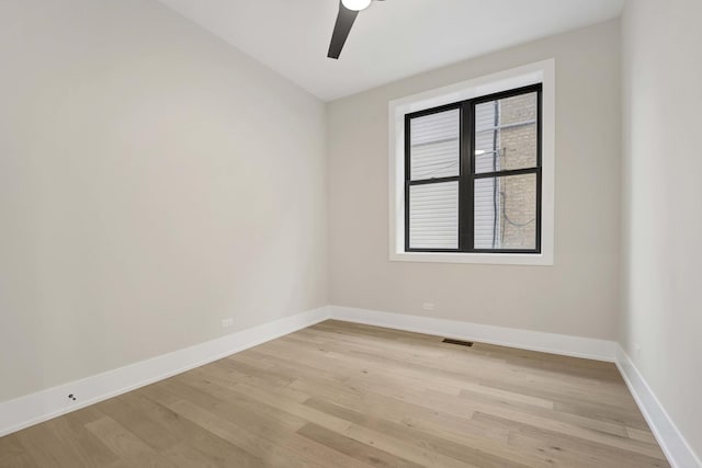 empty room featuring visible vents, baseboards, a ceiling fan, and light wood finished floors