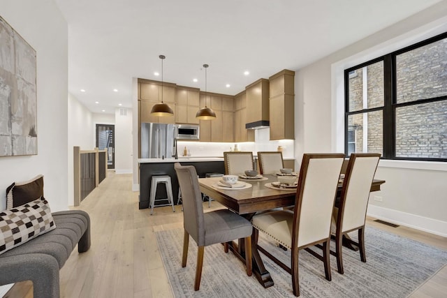 dining area with recessed lighting, visible vents, baseboards, and light wood-style flooring