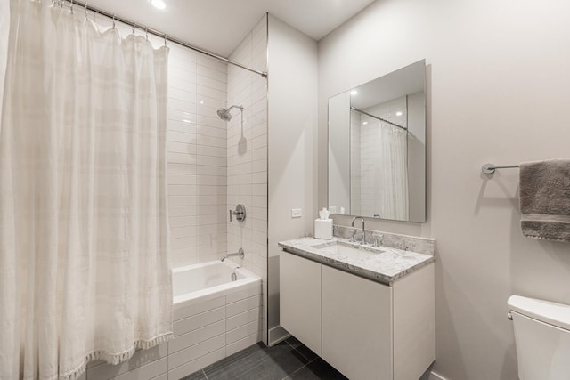 full bathroom featuring tile patterned flooring, vanity, shower / tub combo with curtain, and toilet