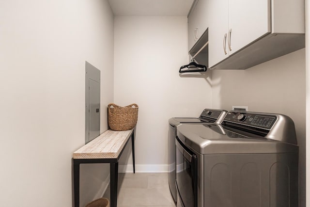 laundry area featuring independent washer and dryer, light tile patterned floors, electric panel, and cabinets