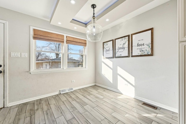 empty room featuring a tray ceiling