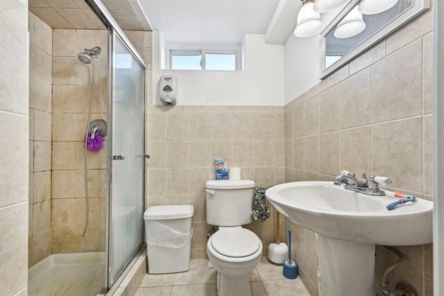 corridor with a raised ceiling, sink, and light hardwood / wood-style floors