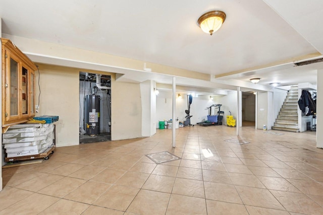 basement with light tile patterned floors and water heater