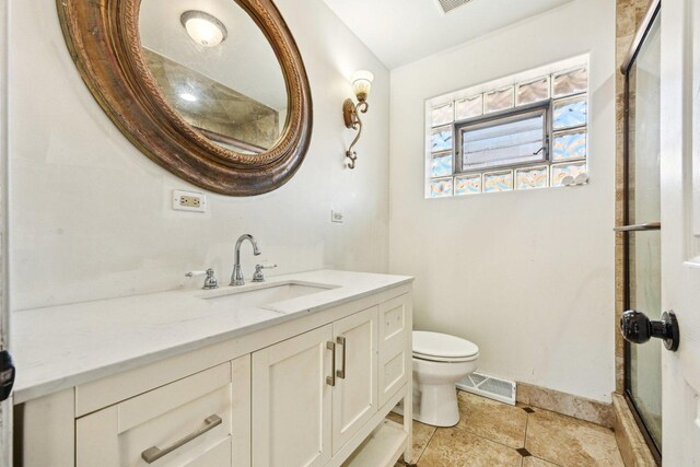 bedroom with hardwood / wood-style floors, a tray ceiling, ornamental molding, a closet, and a chandelier