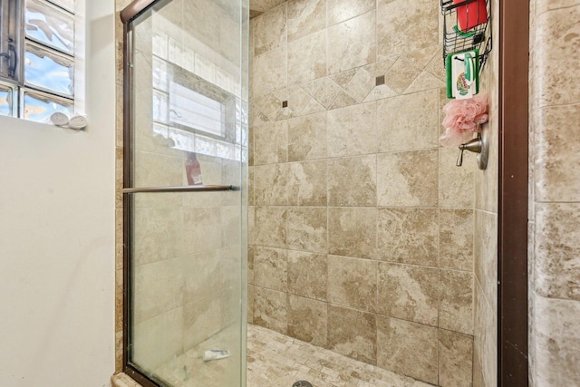 bathroom with a shower with door