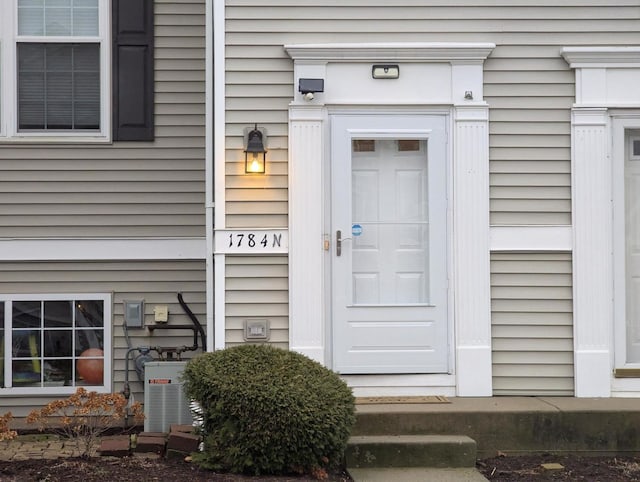 entrance to property featuring cooling unit