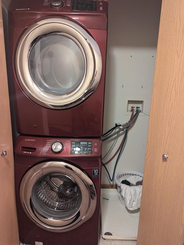 laundry room featuring stacked washer / drying machine