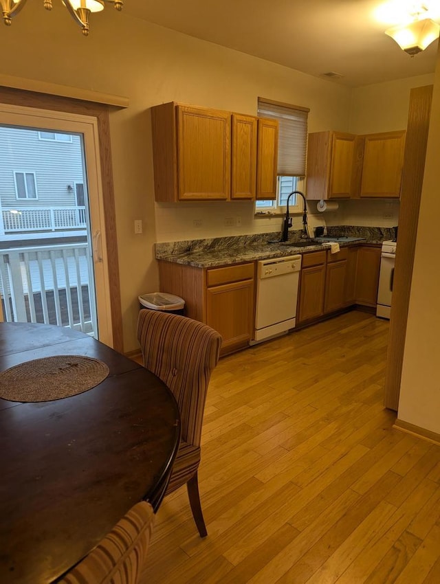 kitchen with sink, white appliances, and light wood-type flooring