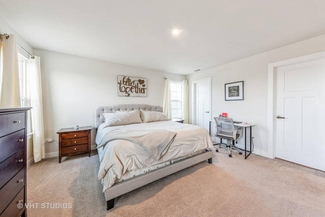 carpeted bedroom with multiple windows