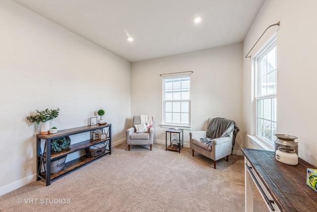 living area featuring light carpet