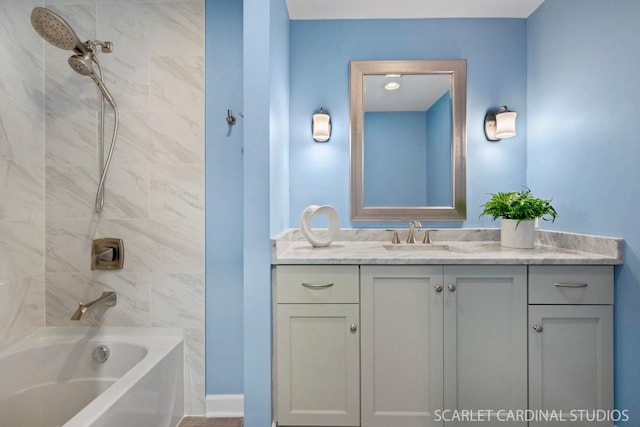 bathroom featuring vanity and tiled shower / bath