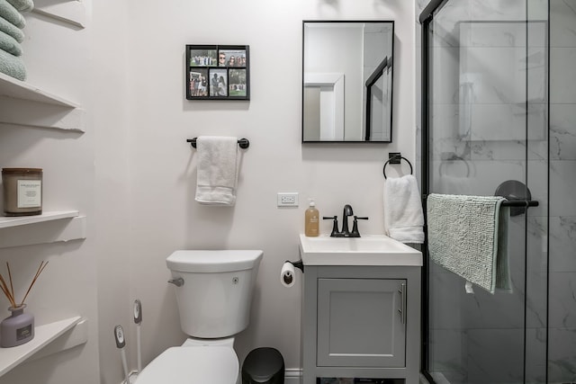 bathroom with vanity, an enclosed shower, and toilet