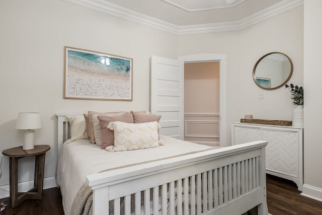 bedroom featuring ornamental molding and dark wood-type flooring