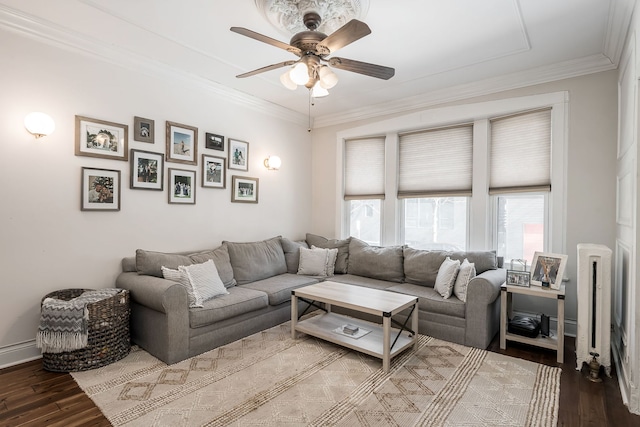 living room featuring hardwood / wood-style flooring, crown molding, and ceiling fan