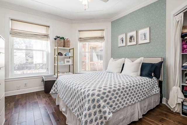 bedroom with multiple windows, dark wood-type flooring, and ceiling fan