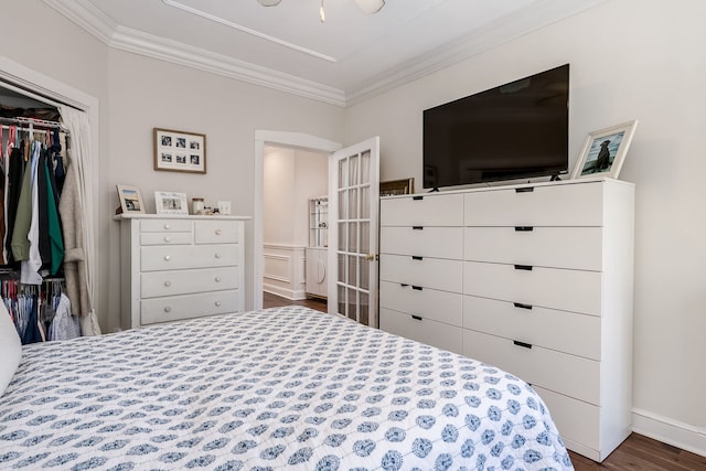 bedroom with ornamental molding, dark hardwood / wood-style floors, and a closet